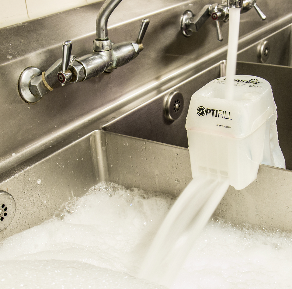 OptiFill positioned on sink divider while filling a 3-compartment sink